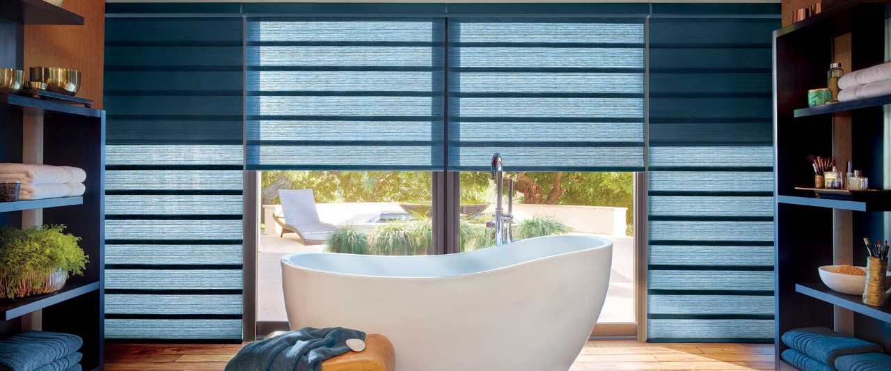 Bathtub in front of blue Vingette Roan Shades.